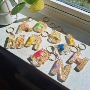 Letter shaped dried flower keychains with gold flakes